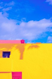 fashion tropical minimal location. yellow synny hotel, palm shadows and blue summer sky. canary islands.  travel aesthetics wallpaper