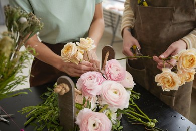 close up of beautiful flower composition with roses and peonies on table in florist workshop, copy space