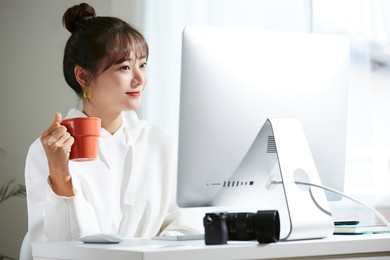 a young asian woman working in the creative industry