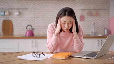 bored sleepy asian lady sitting at desk with laptop, holding head, resting on hand, sleeping at workplace, tired young female feeling drowsy, lazy and unmotivated student, boring job, lack of sleep