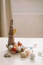 happy easter concept. funny handmade bunny rabbit toy and chicken eggs 