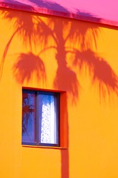 fashion tropical location. palm shadows. yellow house. canary islands. travel advertising banner wallpaper