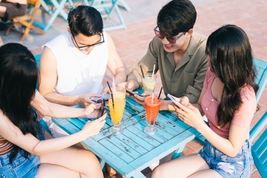 a group of young asians enjoy a trip to the sea on a summer vacation
