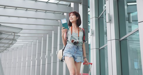asian female traveler walking at the airport and ready to take her flight for summer vacation