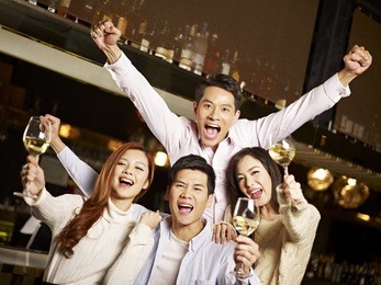 young asian friends couples enjoying party in pub