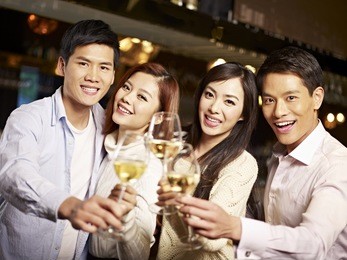 young asian friends couples enjoying party in pub.