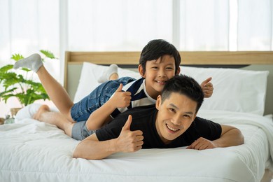 asian business man father work from home and tacking care of son in new normal 