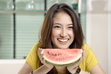 young asian cute woman and eating watermelon