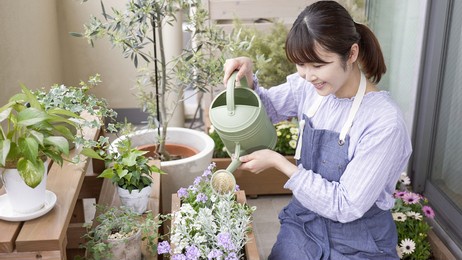 asian women enjoying gardening on the balcony