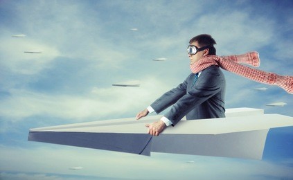 businessman flying on paper plane