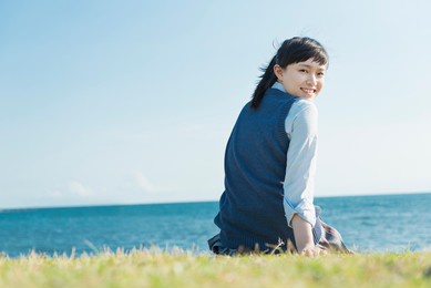 high school girl sitting on a hill