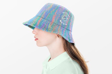 teenage girl in colorful bucket hat with logo for street fashion shoot
