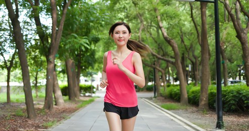 sport asia woman running in the park and enjoy nature