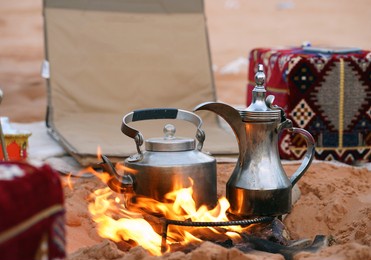 traditional arabic coffee pot and tea pot at the fireplace in the desert, riyadh, saudi arabia