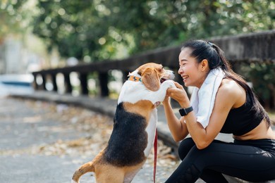 woman and dog running and exercising outdoor in the park