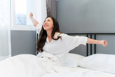 asian woman feeling happy and fresh wake up in the morning.
