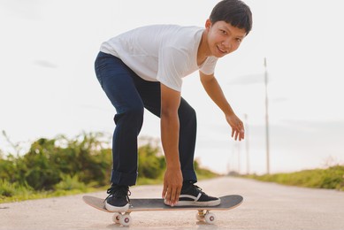 a male skateboarder plays a skateboard in a skate park, the most popular sport of modern people.