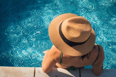 overhead portrait of young woman relaxing in swimming pool. copy space