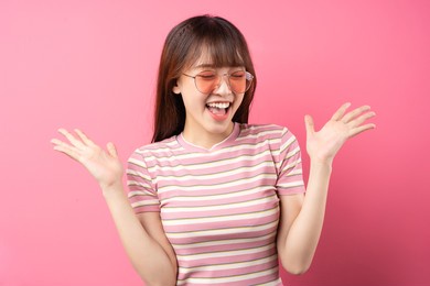 image of young asian girl wearing pink t-shirt on pink background