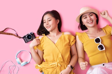 tourist couple in summer casual clothes.asian smiling woman .passenger traveling abroad to travel on pink color background.asian woman going to summer vacation.travel trip funny.