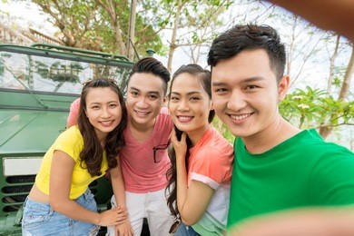 man taking photo of himself and his friends