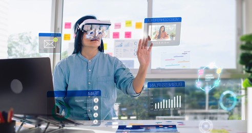 asian woman using augmented reality (ar) and mixed reality glasses simulation meeting and working with hologram over table at office.virtual reality development process concept