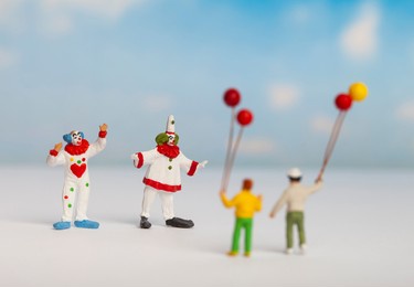 children's holiday concept. clown and miniature kids holding balloons