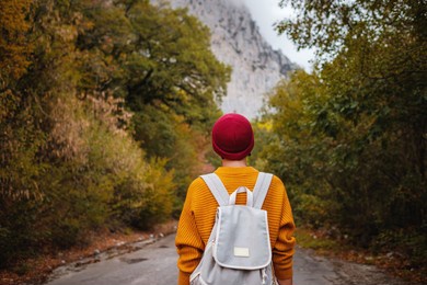 outdoor fashion photo of young beautiful asian lady surrounded autumn forest in mountains. portrait of romantic hipster female, warm autumn weather, calm scene. wanderlust photo series.