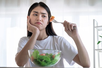 asian woman feel anorexia, the girl does not like to eat vegetables, healthy food.