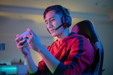 asian man have live stream and playing mobile game on the smartphone at home