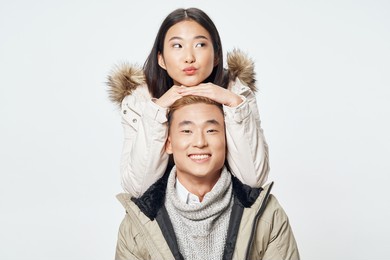 man and woman from above on a light background friends fun emotions asian appearance