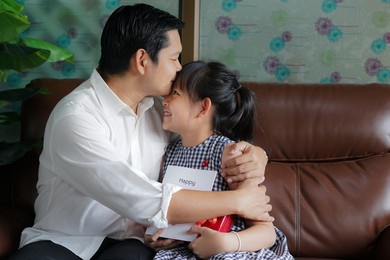 father was lovingly kissing his daughter's forehead.concept of happy father's day