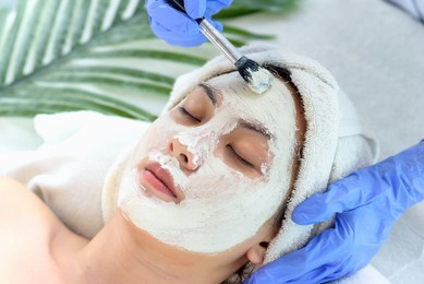 young asian women getting facial care, facial masks, and spa beauty treatment for soft smooth silky skin by beauticians at spa salon. beauty skincare concept