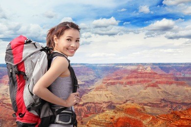 woman mountain hiker with backpack enjoy view in grand canyon, asian