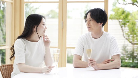 young asian couple drinking sparkling wine in the terrace