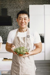 asian man prepare dinner in a kitchen