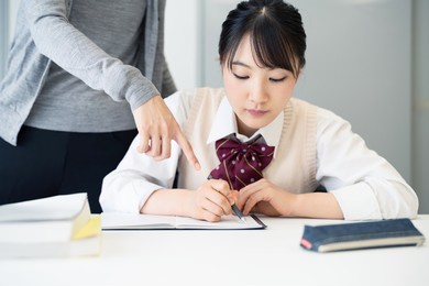 asian school girl studying in the classroom. cram school. private teacher.