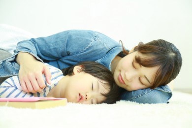 parent and child taking a nap 
