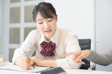 asian school girl studying in the classroom. cram school. private teacher.