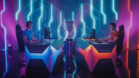 two professional esport gamers competition in a video game on a championship arena, both playing computer games. global online streaming cyber games tournament