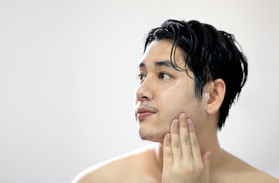 portrait of asian men are washing their face with foam , men skin care concept. beauty, people and hygiene concept. 