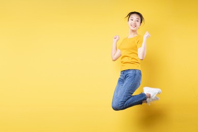 photo portrait full length of cheerful girl jumping up celebrating victory isolated on pastel blue colored background