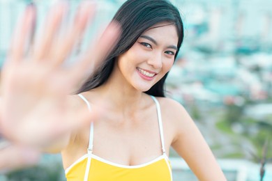 asian young woman relax in swimming pool at luxury hotel spa enjoying beautiful  .close up  female enjoying summer .travel in city happy enjoy at rooftop city bangkok.
