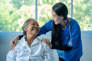 doctor taking cake of elderly woman in hospital, asian female doctor take care and discussing with elderly patient in hospital, health care and empathy concept.