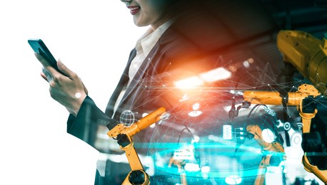 mechanized industry robot arm and factory worker double exposure . concept of robotics technology for industrial revolution and automated manufacturing process .