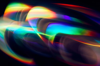 blurred light painting one exposure in camera. light glares with a spectral gradient on a dark background. multicolored abstract colorful line. unusual light effect.