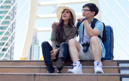 couple asian tourists and traveling in the city happily
