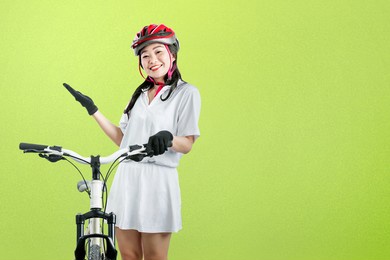 asian woman with a bicycle helmet standing beside her bicycle with colored background