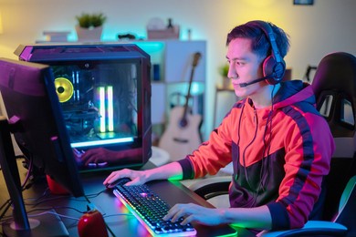 young asian handsome pro gamer playing online cyber sport game at home