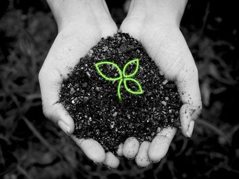 young digital green plant in hand. close-up hand holding leaves, neon graphic style in organic soil on dark, black and white. technology, ecology, earth day, agriculture and gardening concept.